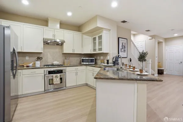 a kitchen with sink cabinets and stainless steel appliances