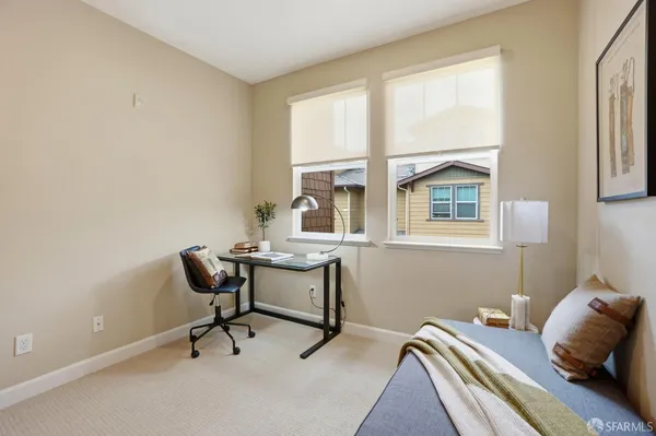 a bedroom with a bed and a couch