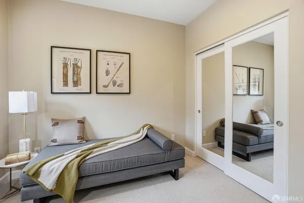 a bedroom with a bed and painting on the wall