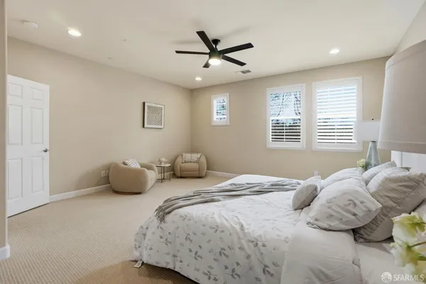 a bedroom with a bed and lamp