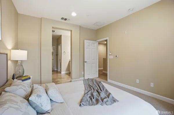 a bedroom with a large bed and a window
