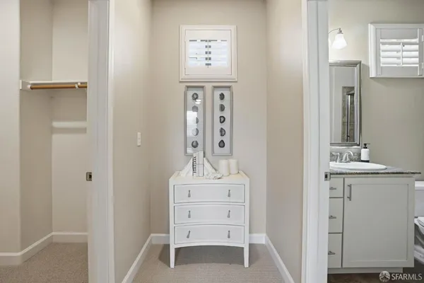a bathroom with a granite countertop sink a toilet and shower