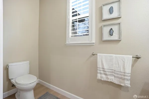 an empty room with a ceiling fan and windows