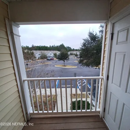 a view of a balcony with wooden floor