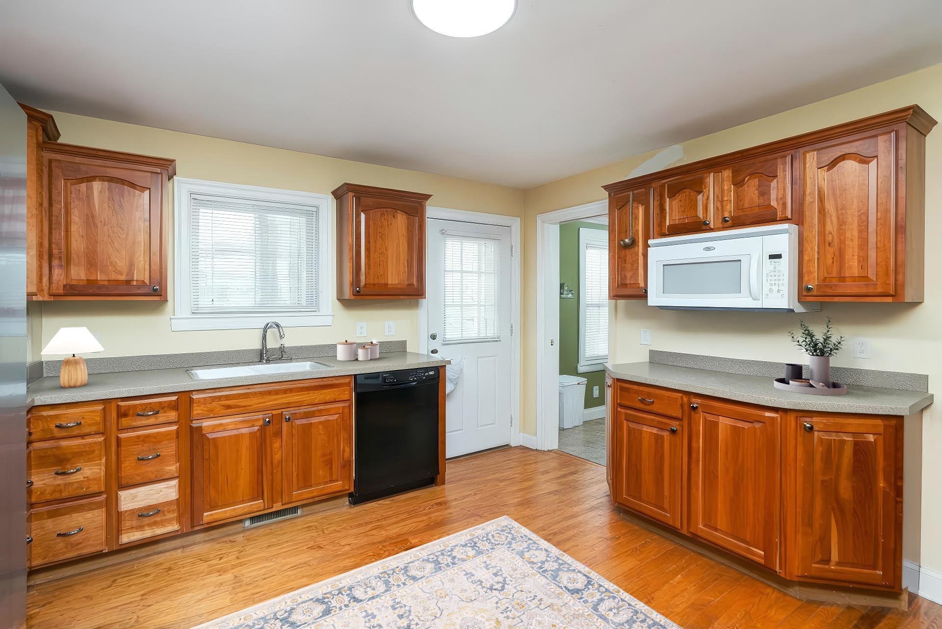 86 Spitler Circle Greenville, VA 24440 - Photo 6 of 25 a kitchen with stainless steel appliances granite countertop a sink stove and wooden cabinets