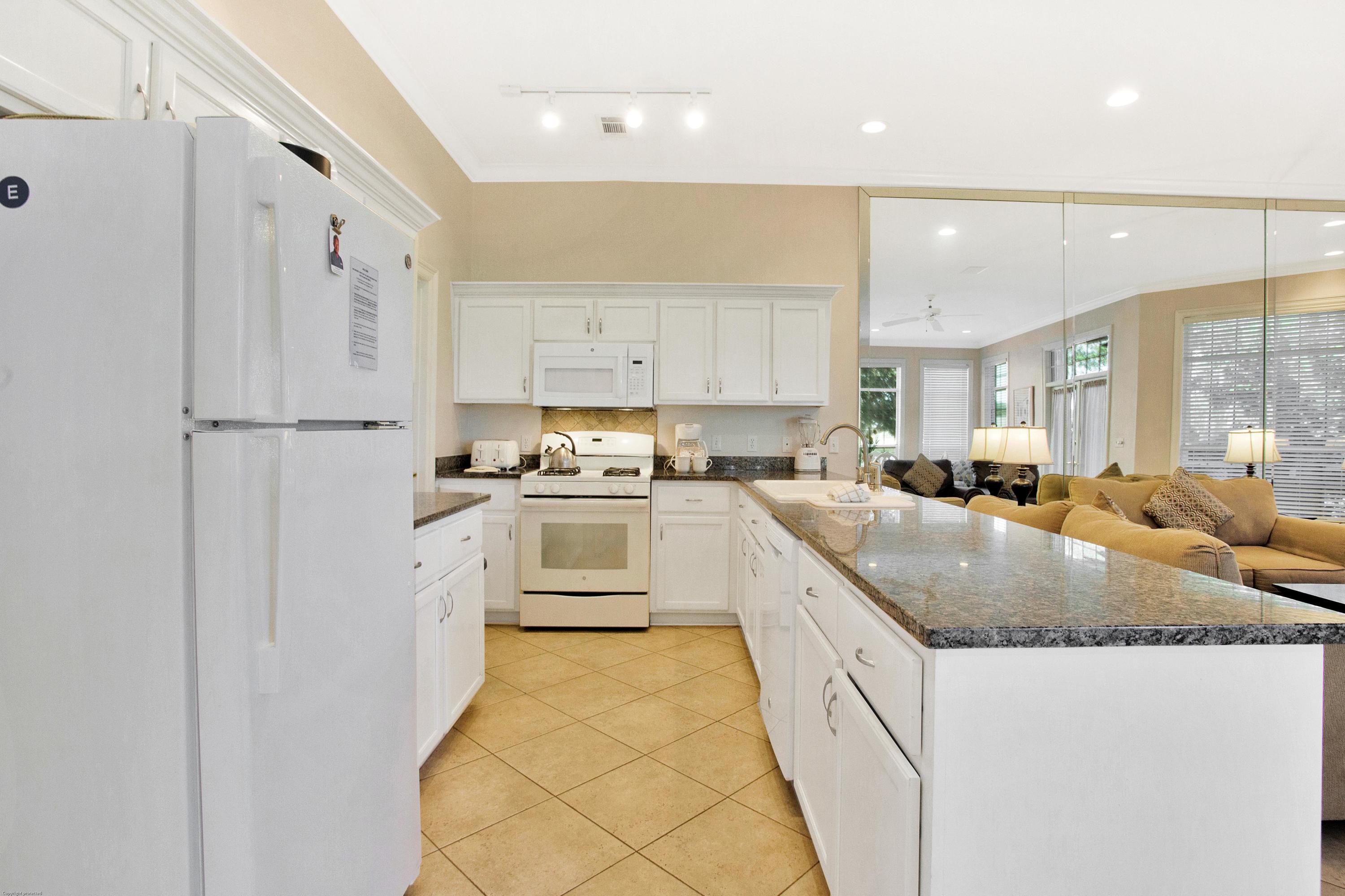 71 Vantage Point Miramar Beach, FL 32550 - Photo 2 of 36 a white kitchen with granite countertop a sink a counter top space stainless steel appliances and cabinets