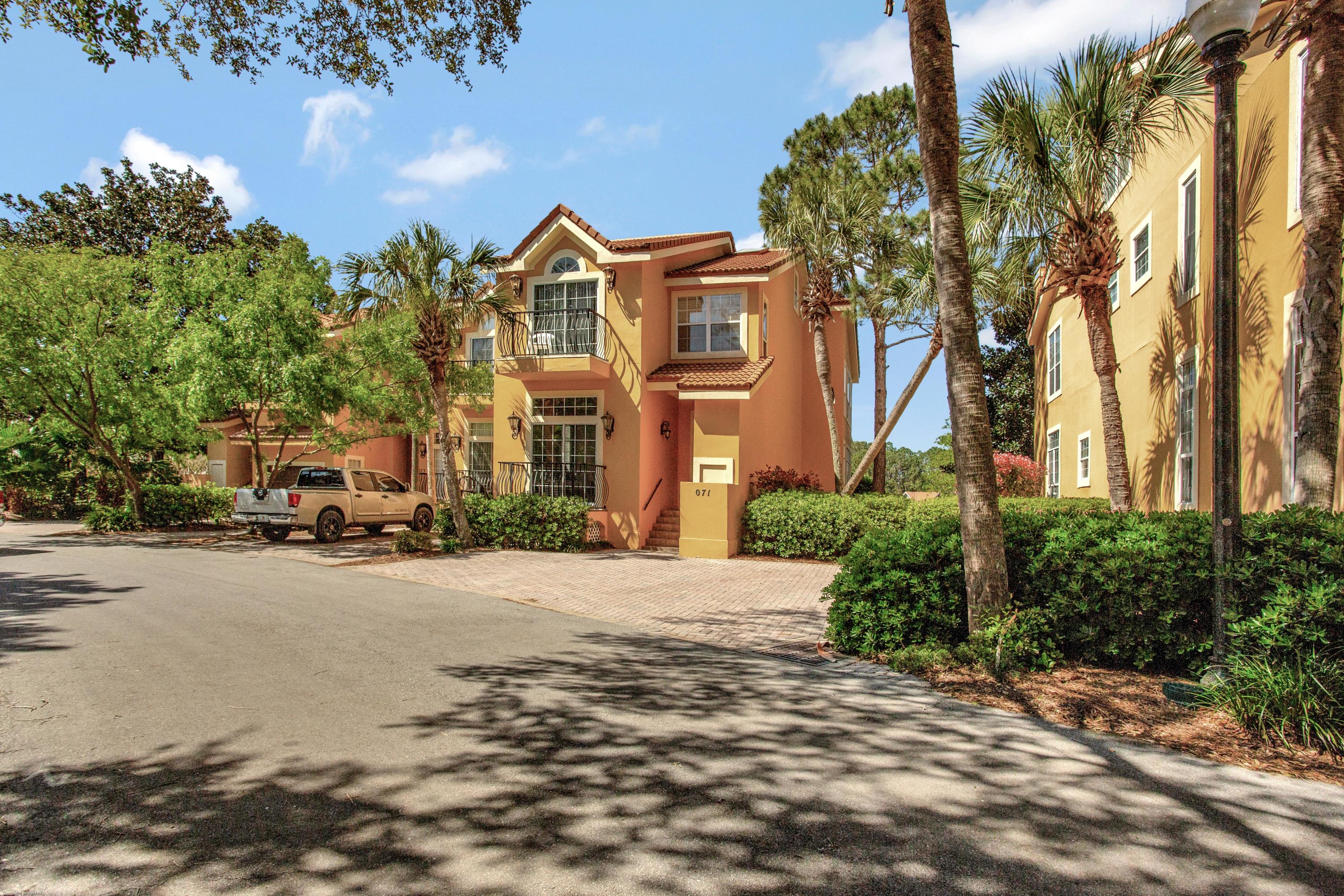 71 Vantage Point Miramar Beach, FL 32550 - Photo 33 of 36 a front view of a house with a yard and a car parked on street
