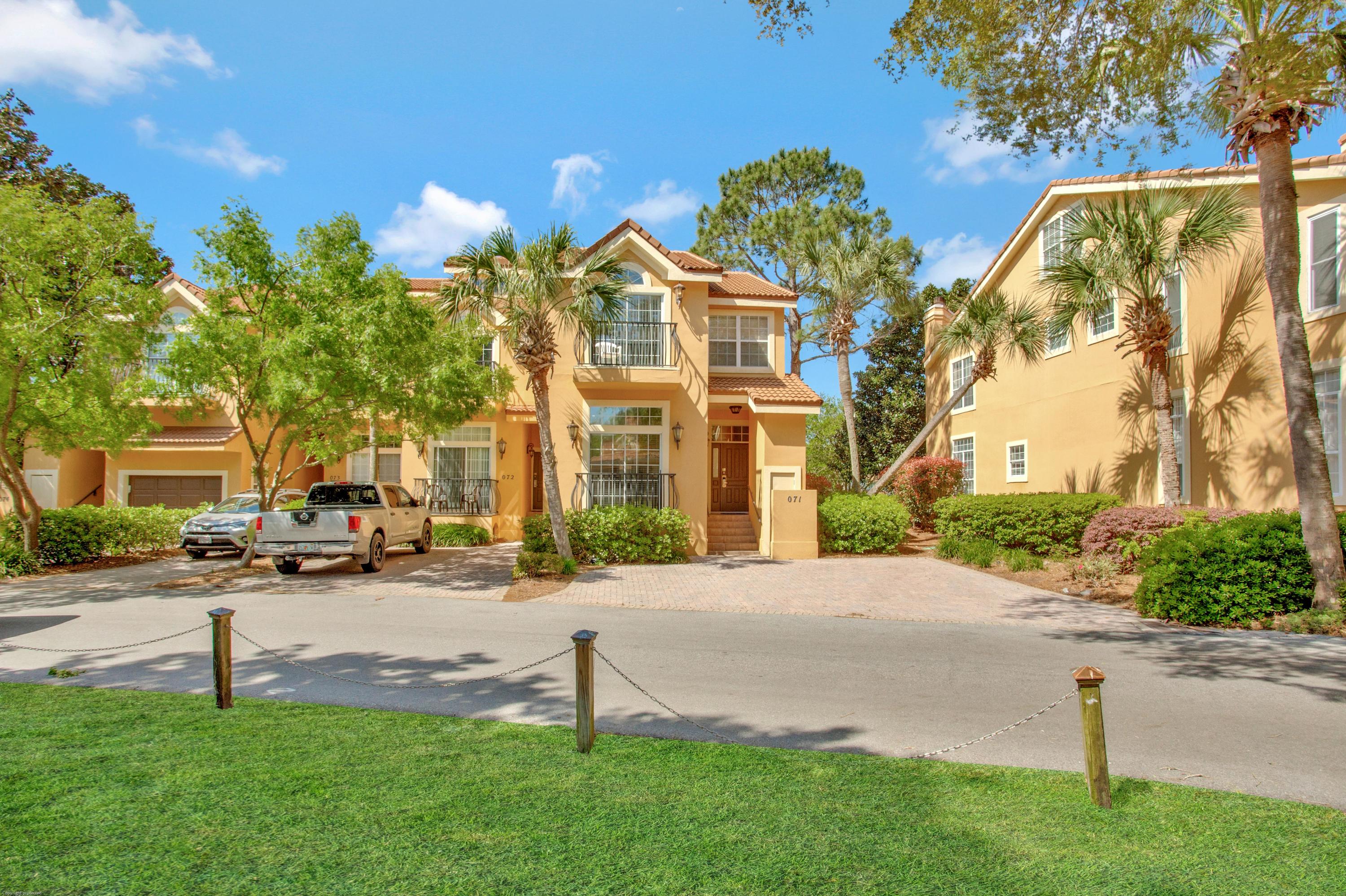 71 Vantage Point Miramar Beach, FL 32550 - Photo 35 of 36 a front view of a house with a yard and trees