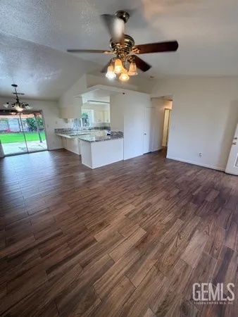 a view of a room with wooden floor