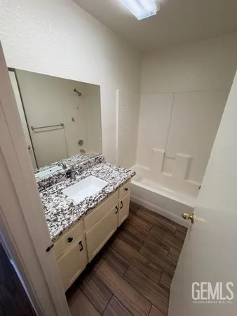 a view of room with wooden floor