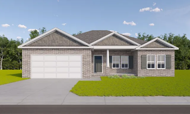 a front view of a house with a garden and yard