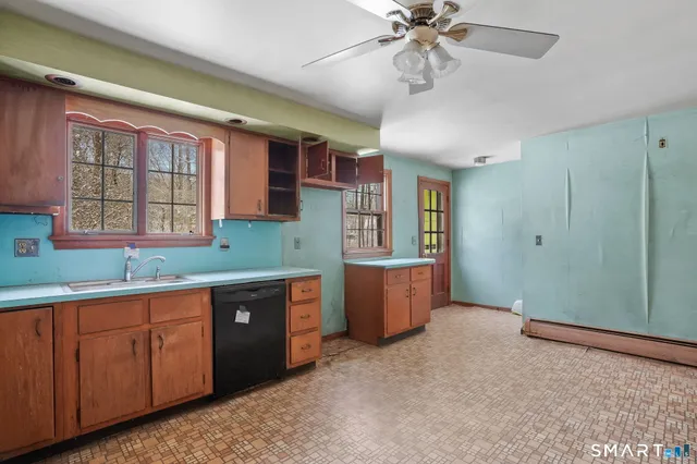 a kitchen with granite countertop a stove and cabinets