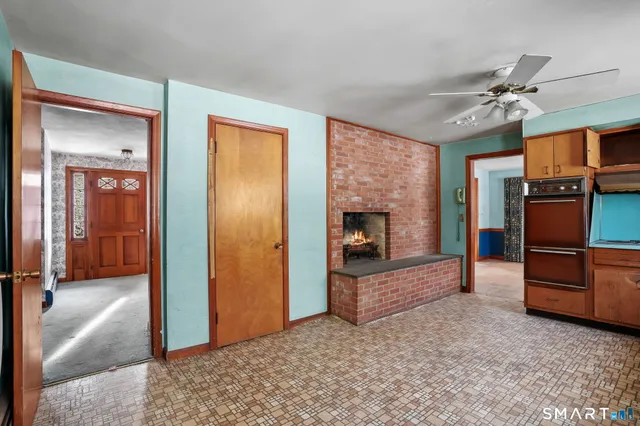 a kitchen with stainless steel appliances kitchen island granite countertop a refrigerator and a stove top oven