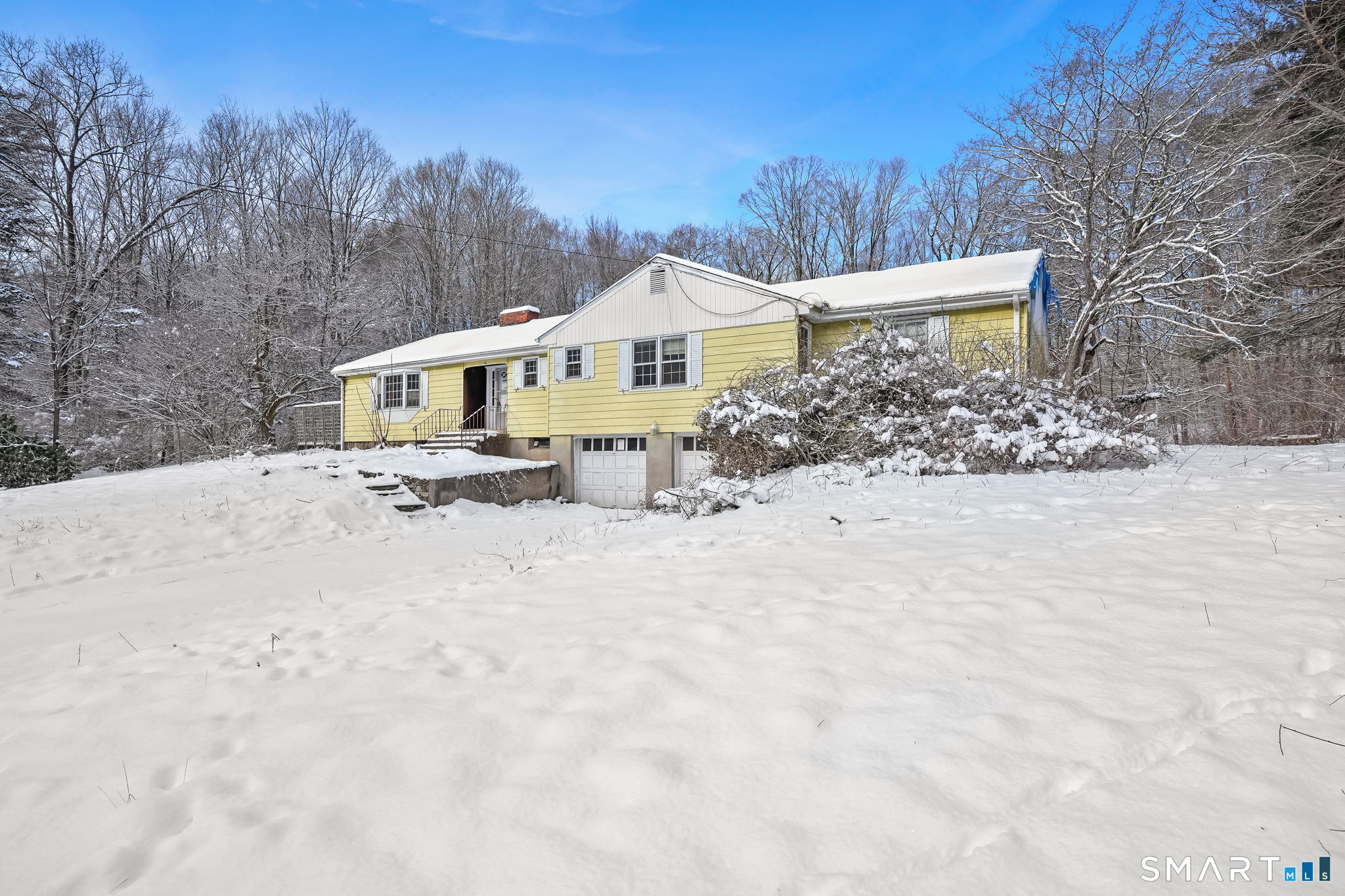 10 Pasture Lane Simsbury, CT 06092 - Photo 2 of 40 a view of a house with a yard covered in snow