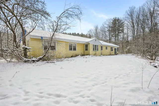 a view of a house with a snow in the yard