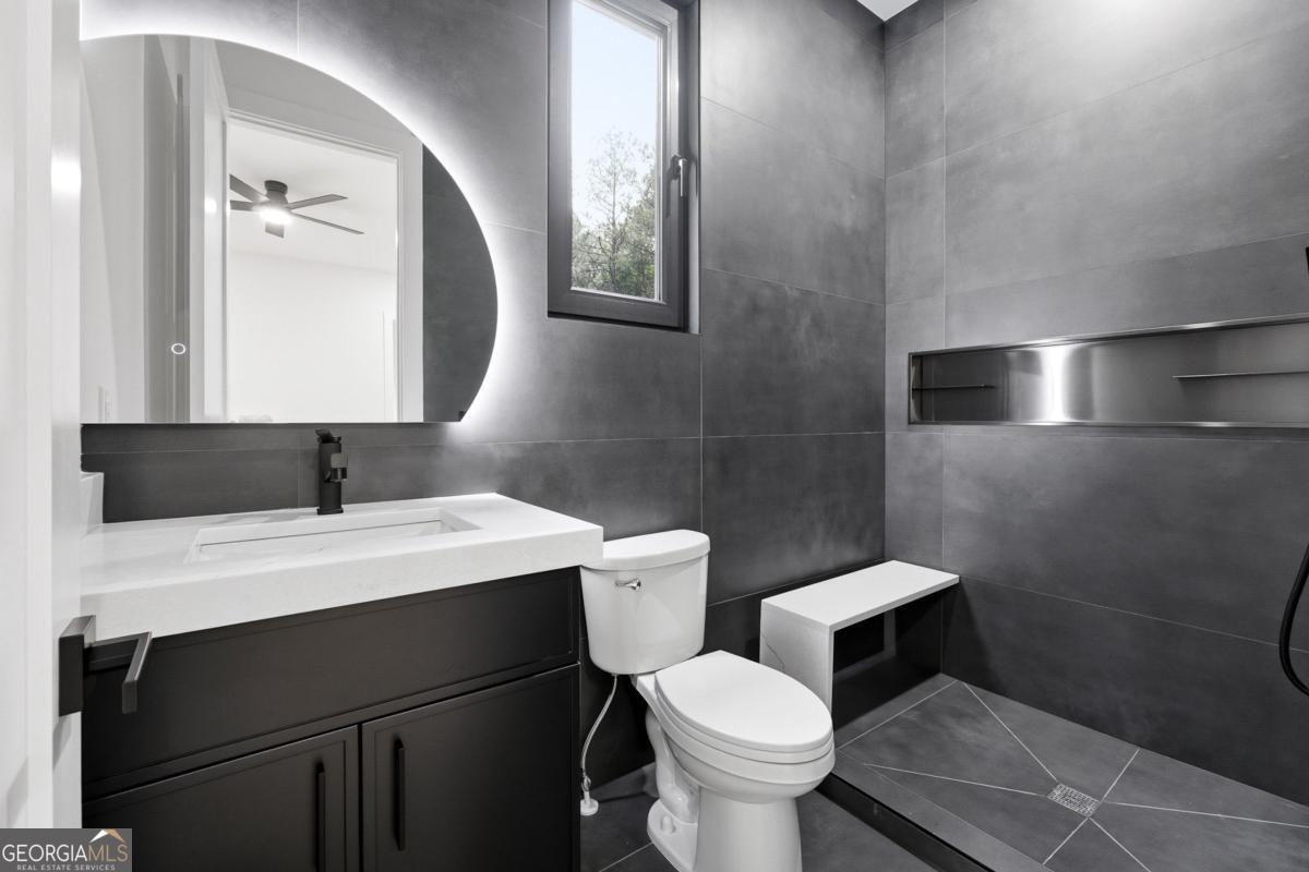 1563 Whitley Road Bethlehem, GA 30620 - Photo 32 of 44 a bathroom with a toilet sink and mirror
