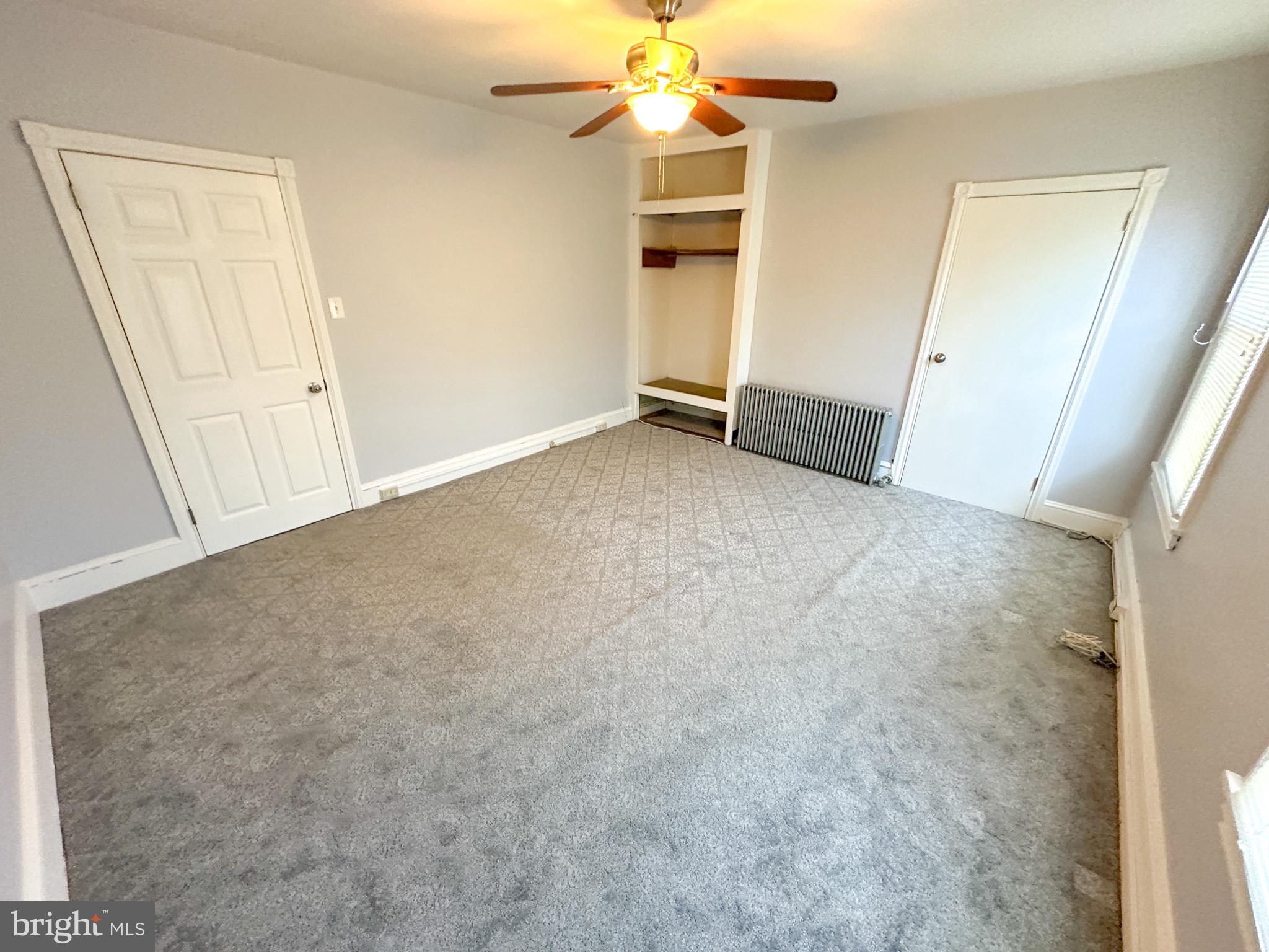 437 Markle Street Philadelphia, PA 19128 - Photo 10 of 20 an empty room with a ceiling fan and window