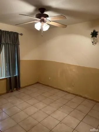 an empty room with a view of a garage