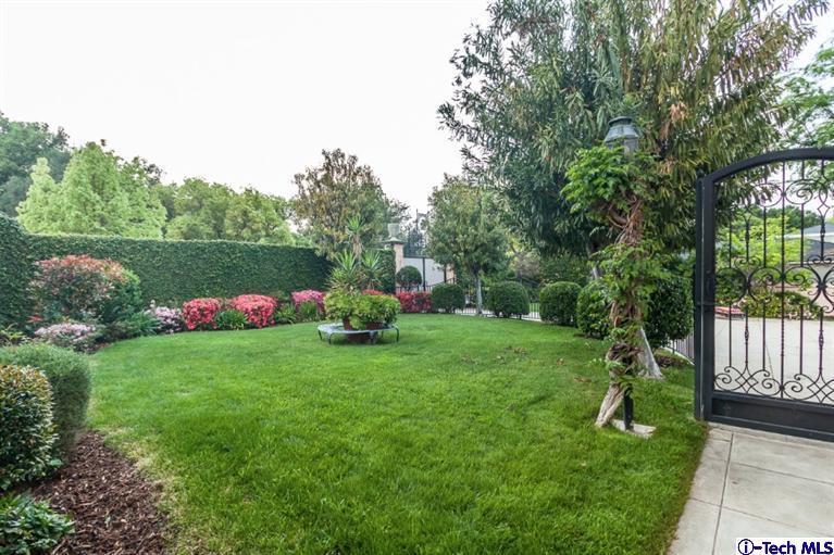 1126 Hillcrest Avenue Pasadena, CA 91106 - Photo 64 of 67 a backyard of a house with table and chairs plants and large tree