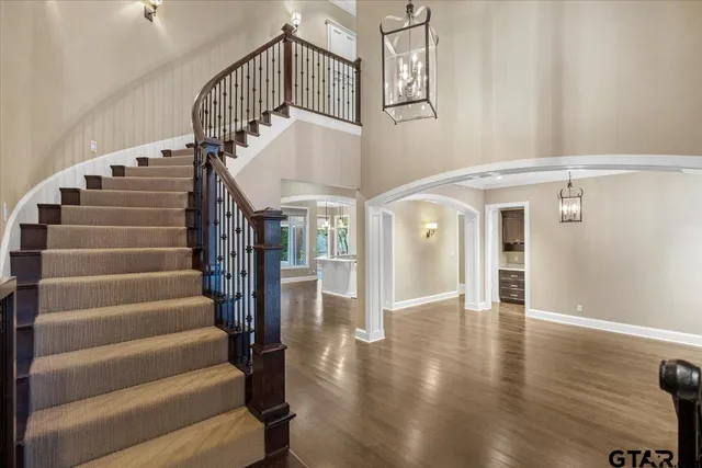 a view of entryway and hall with wooden floor
