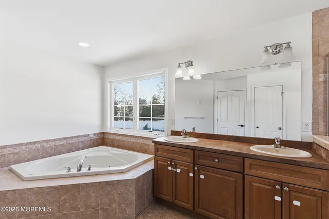 a bath tub sitting next to a bathroom sink
