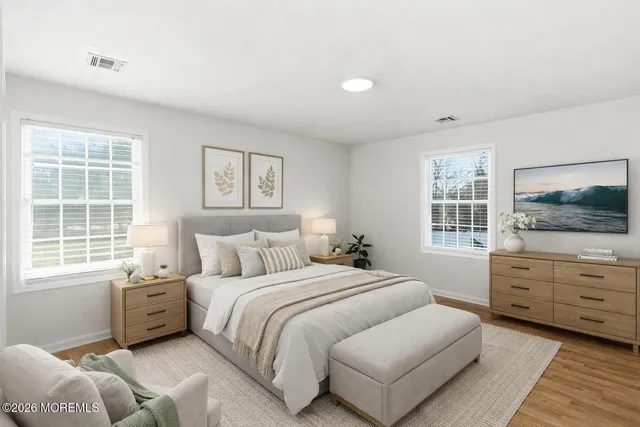 a bedroom with a bed a window and dresser