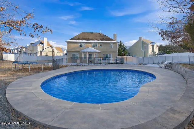 a view of a swimming pool with a yard