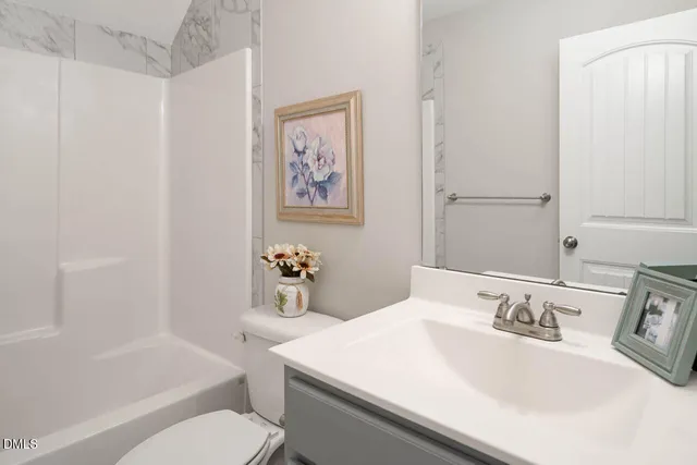 a bathroom with a sink a toilet and bathtub
