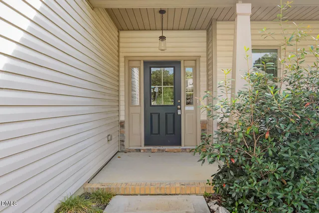 front view of a house with a potted plant