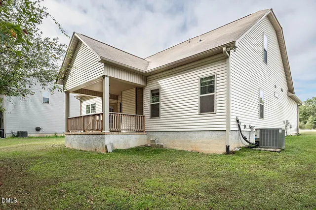 a view of a house with a yard and a garage