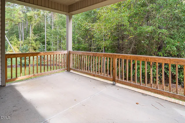 a view of a balcony with yard