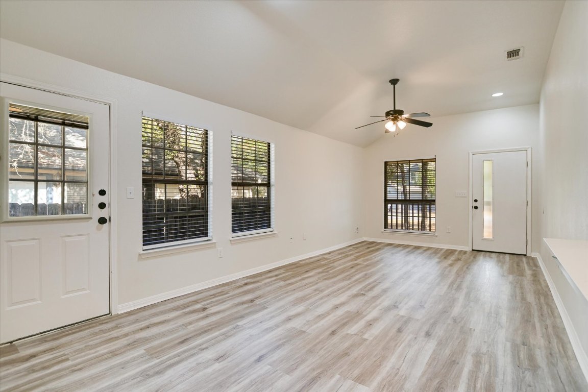 3407 Blumie Street, Unit B Austin, TX 78745 - Photo 2 of 10 a view of an empty room with a window and wooden floor