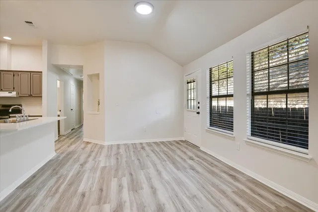 a view of wooden floor and windows in a room