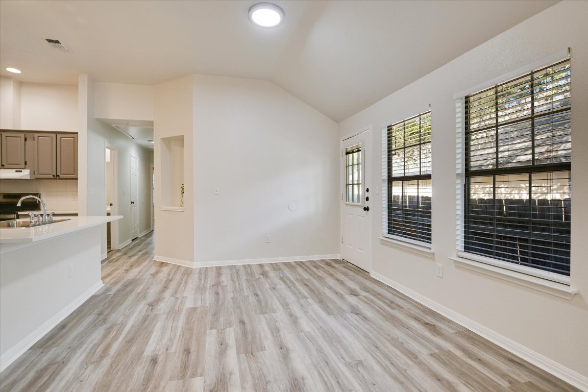 3407 Blumie Street, Unit B Austin, TX 78745 - Photo 3 of 10 a view of wooden floor and windows in a room