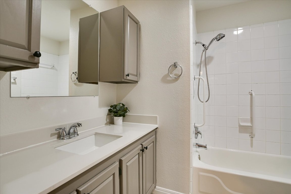 3407 Blumie Street, Unit B Austin, TX 78745 - Photo 6 of 10 a bathroom with a tub sink vanity and mirror