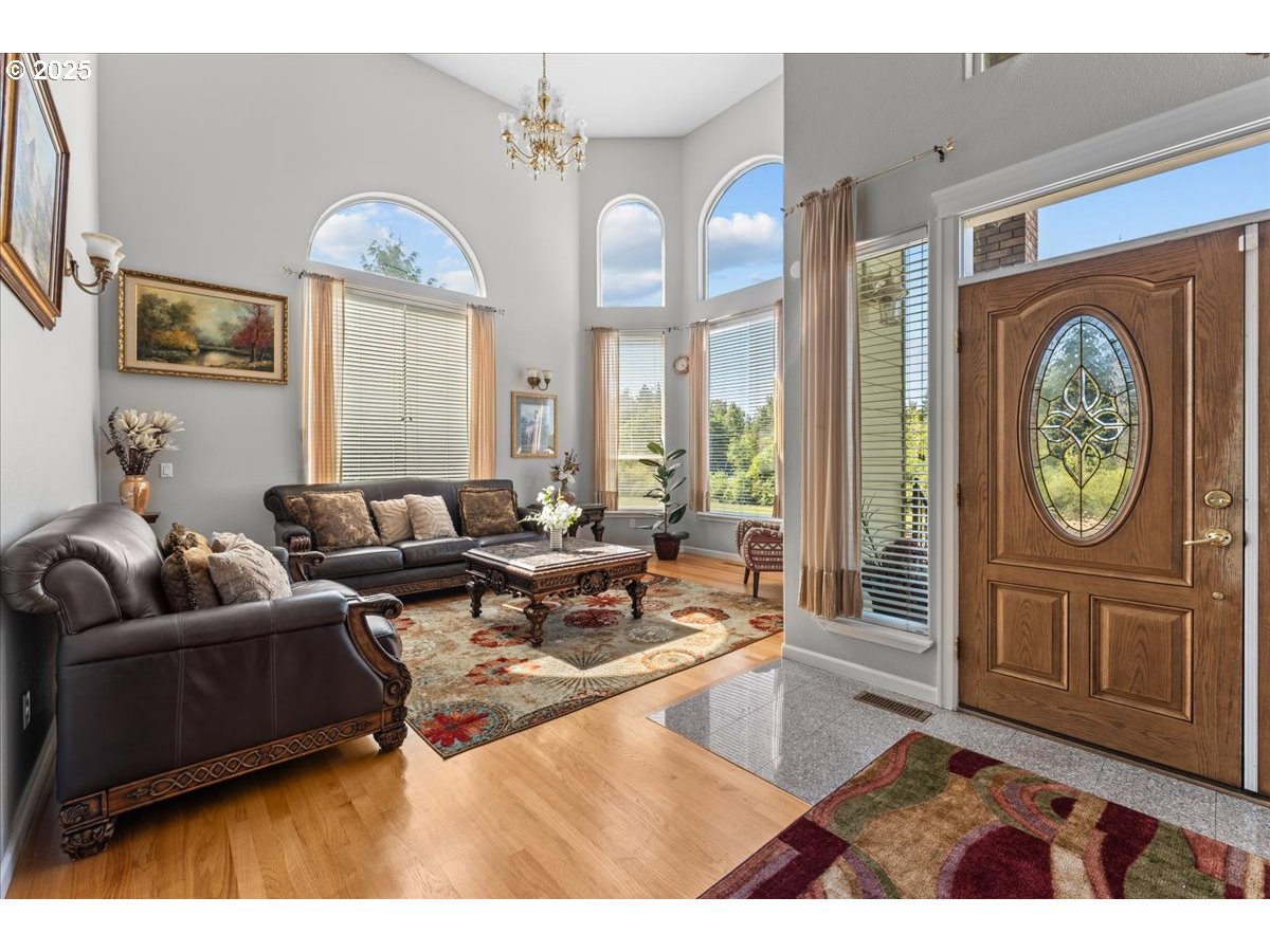 5122 Southeast Jenne Road Portland, OR 97236 - Photo 15 of 36 a living room with furniture a large window and wooden floor