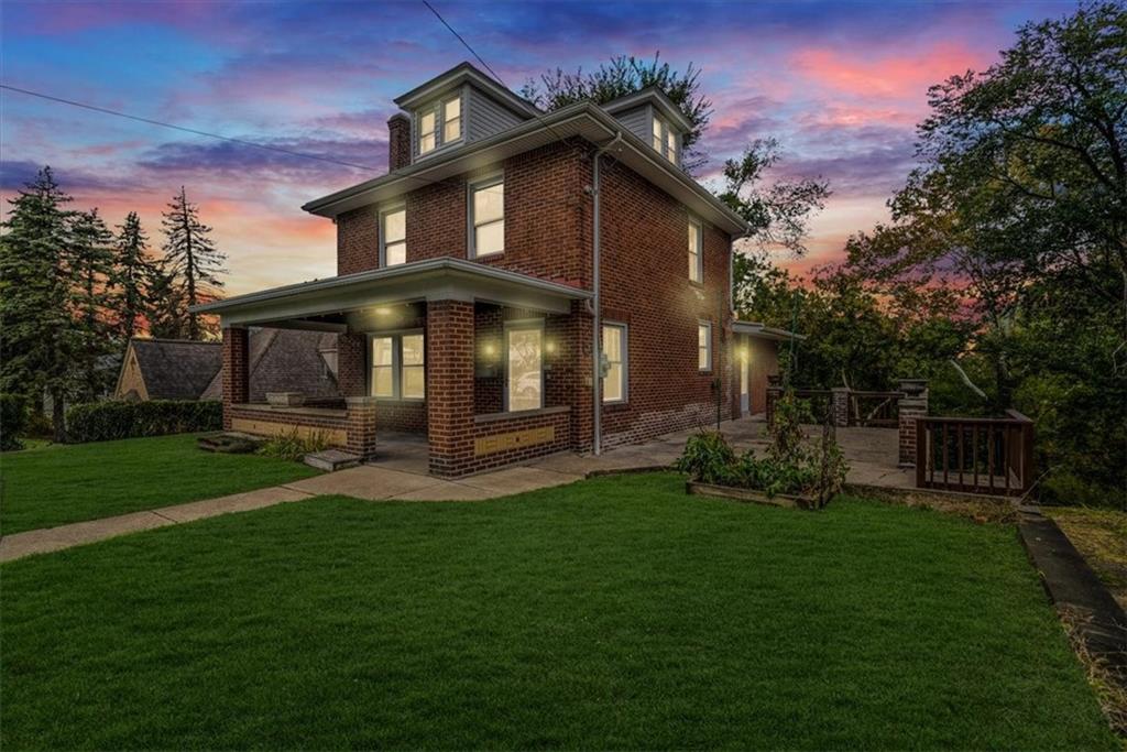 a front view of a house with a garden