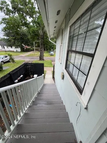 a view of a balcony with wooden floor
