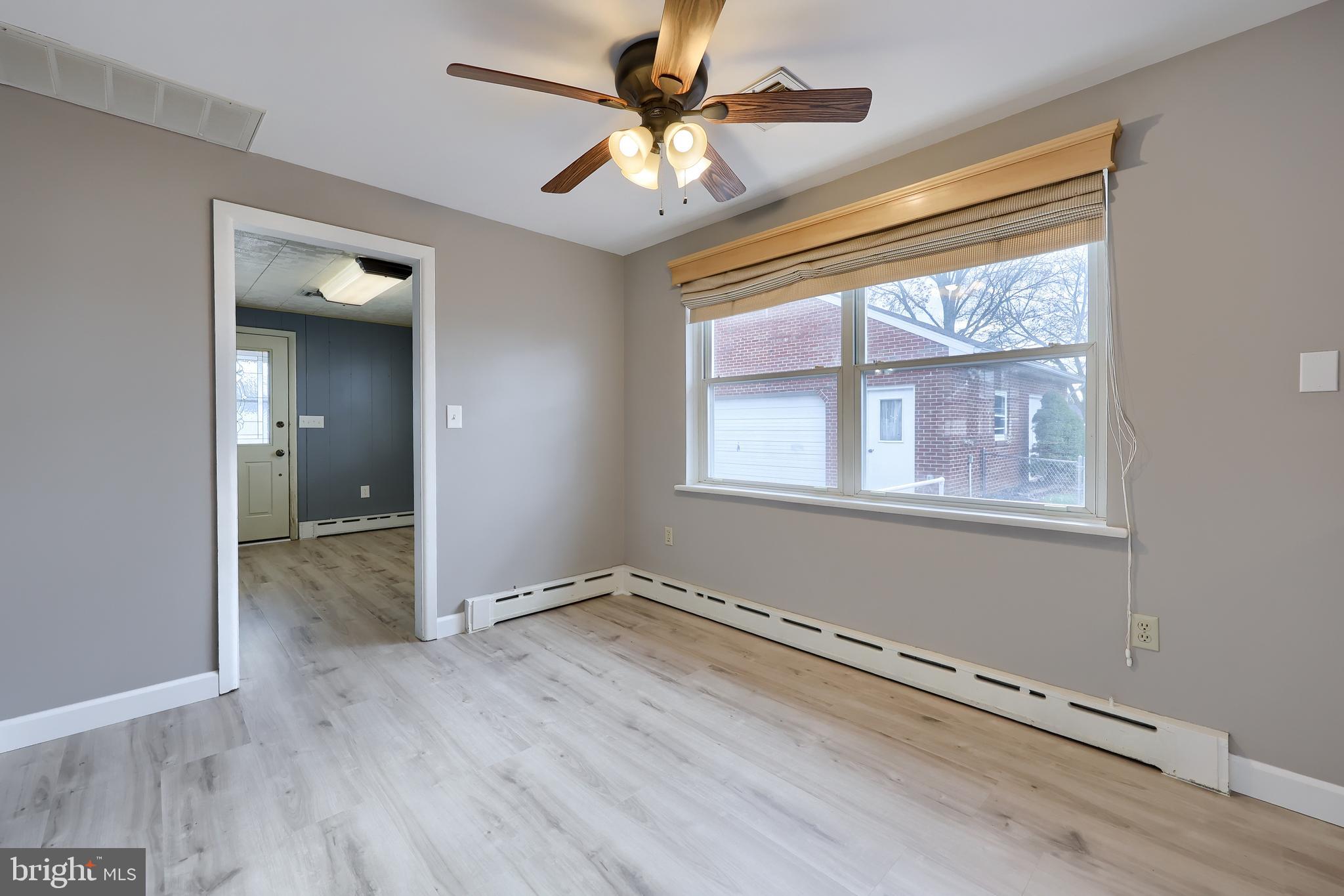705 Summit Drive Dallastown, PA 17313 - Photo 12 of 50 a view of an empty room with a window and wooden floor
