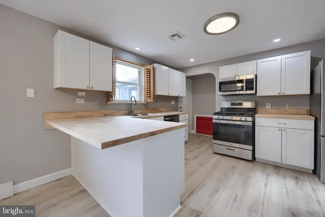 a kitchen with granite countertop a sink and steel appliances