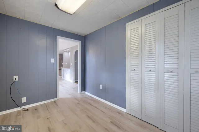 a view of a room with wooden floor and bathroom