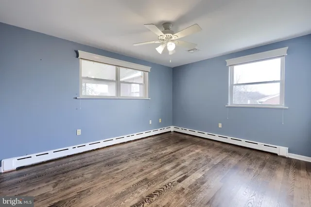 a view of a room with wooden floor and window