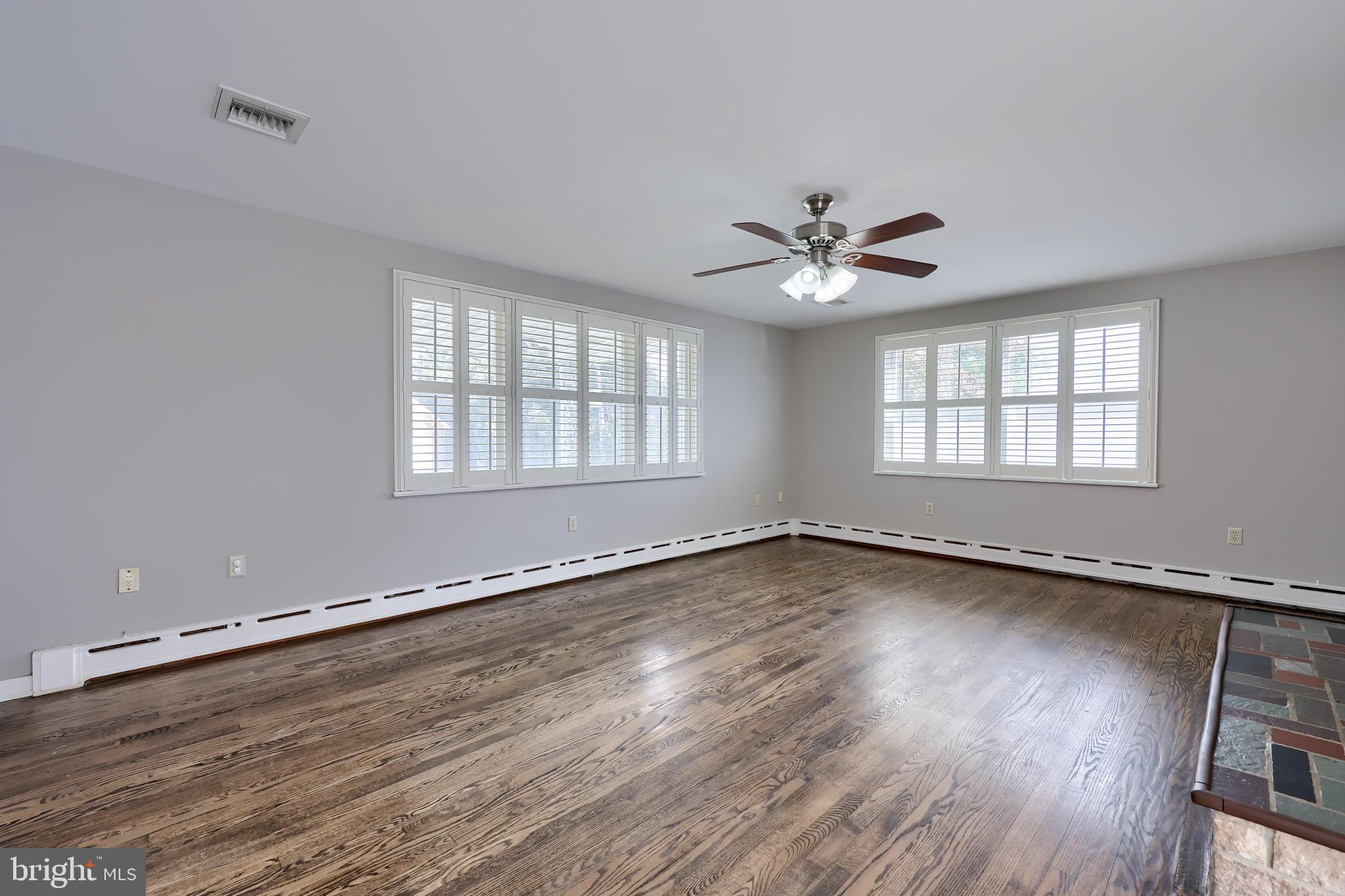 705 Summit Drive Dallastown, PA 17313 - Photo 7 of 50 an empty room with wooden floor and windows