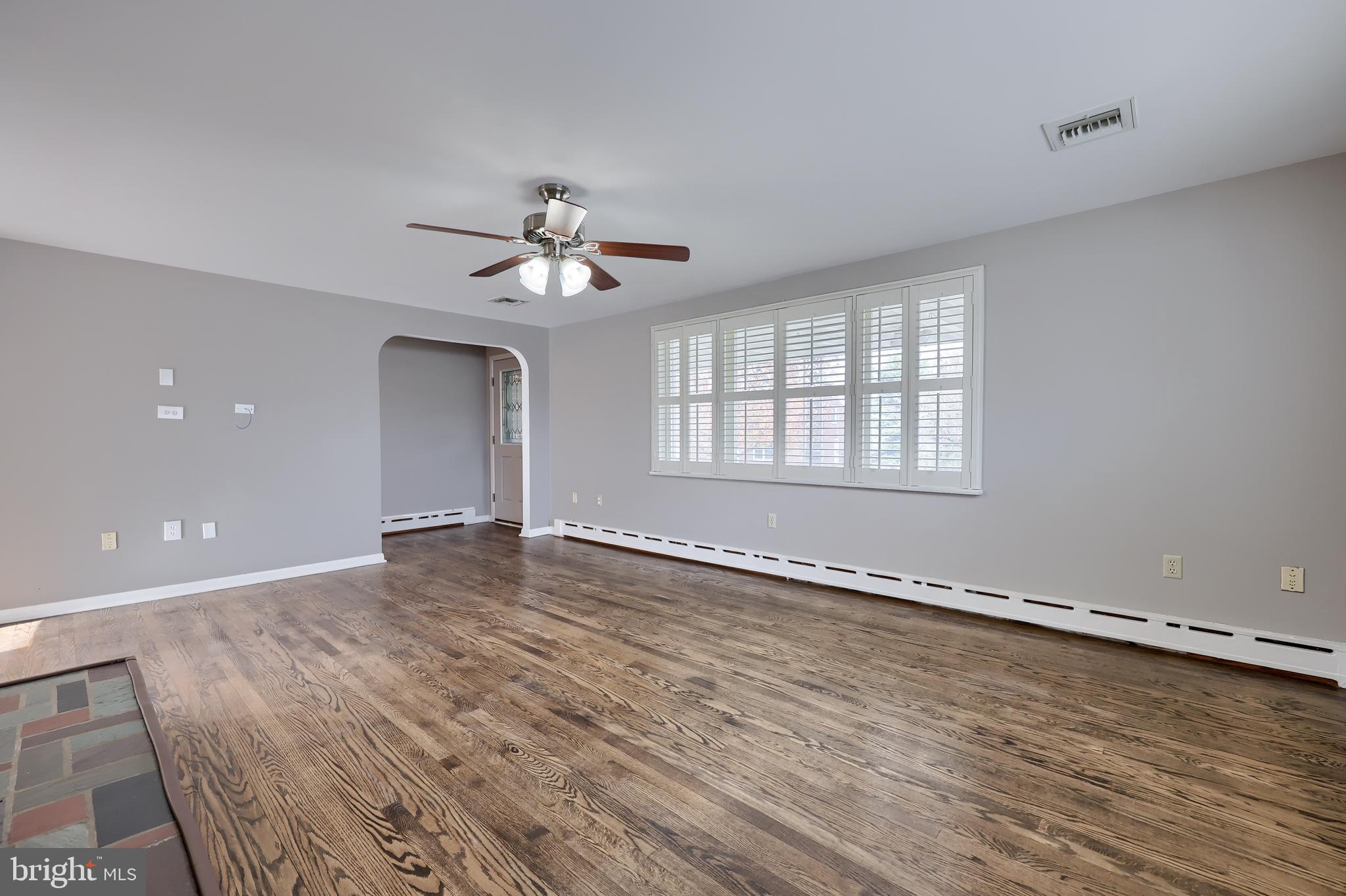 705 Summit Drive Dallastown, PA 17313 - Photo 8 of 50 a view of an empty room with a window and wooden floor