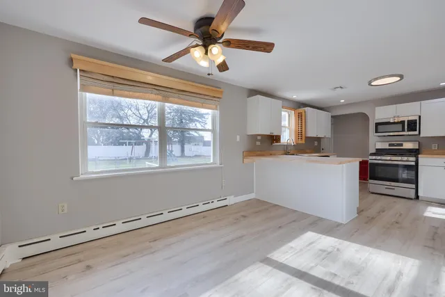 a kitchen with granite countertop a stove cabinets and a window
