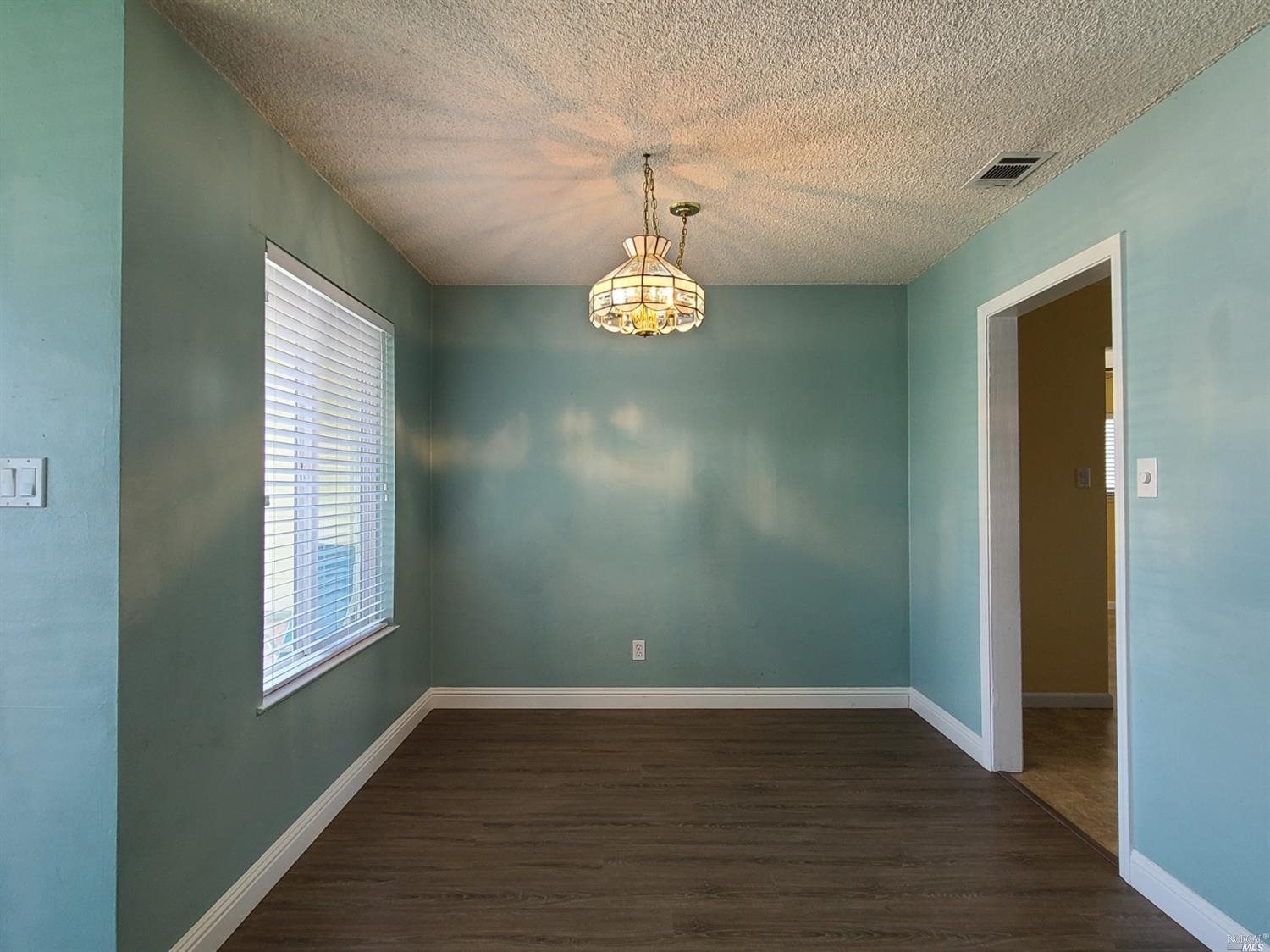 129 Maple Street Vacaville, CA 95688 - Photo 3 of 14 a view of a room with window and wooden floor