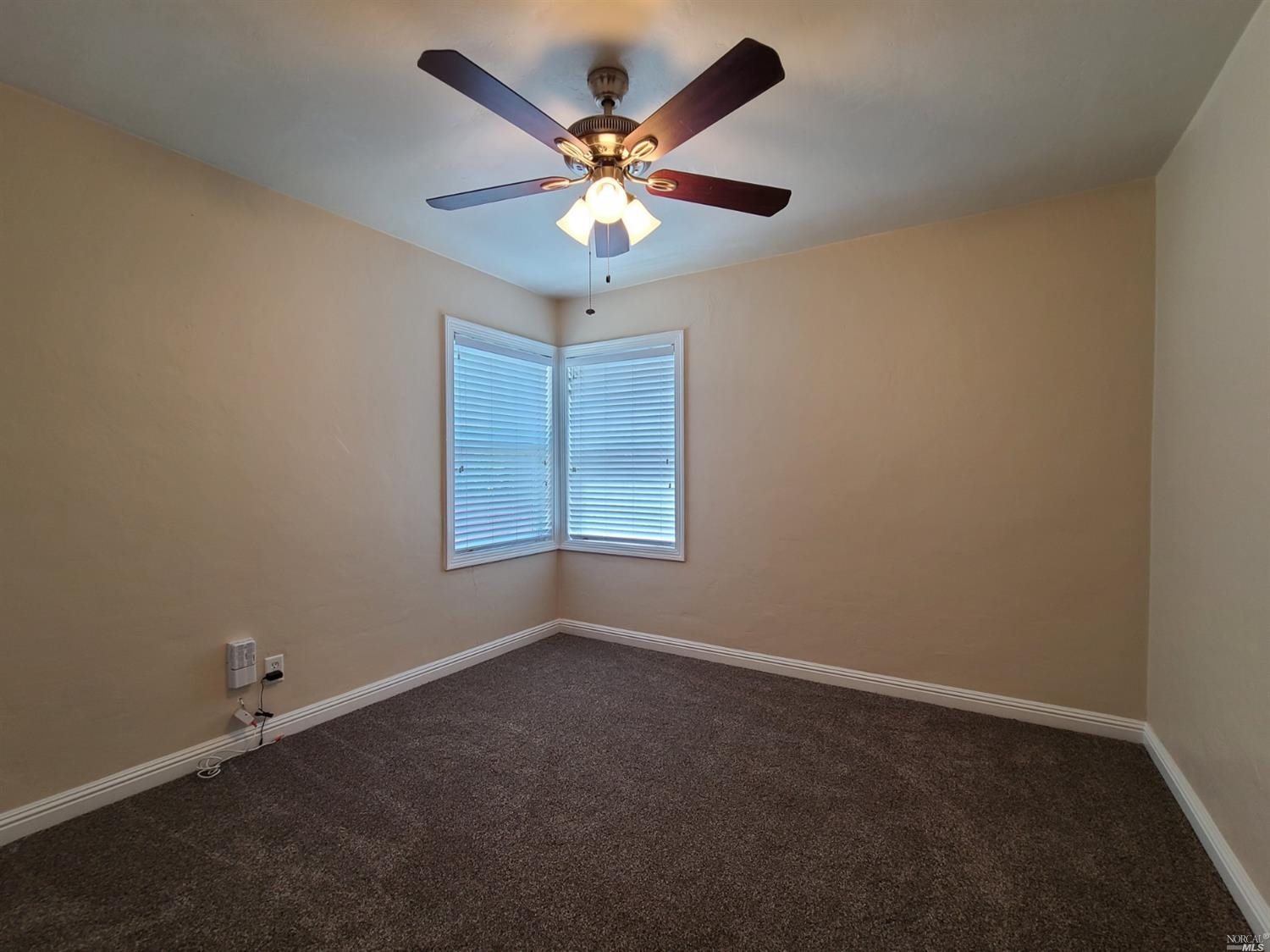129 Maple Street Vacaville, CA 95688 - Photo 6 of 14 wooden floor in an empty room with a window
