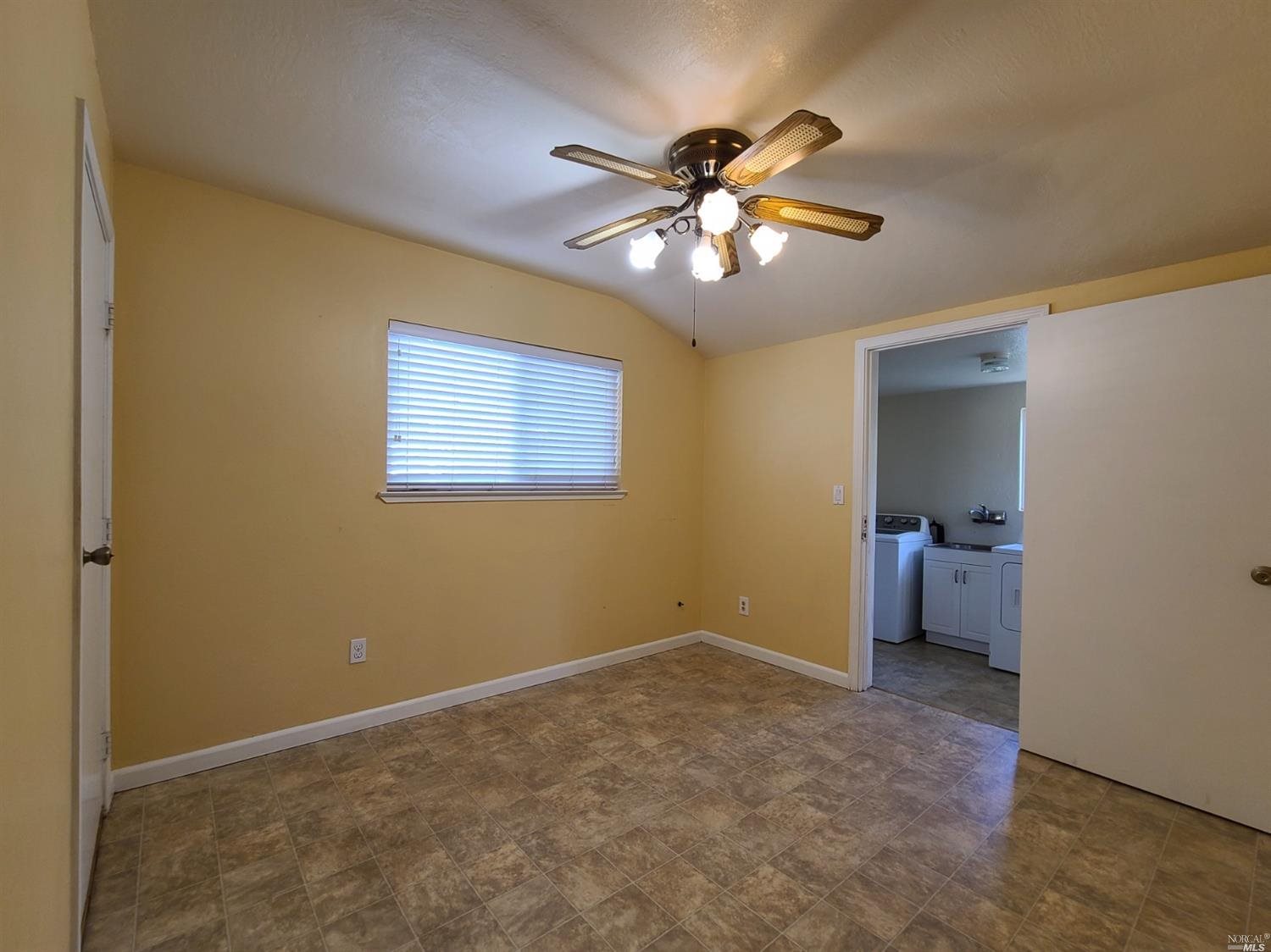 129 Maple Street Vacaville, CA 95688 - Photo 8 of 14 a view of an empty room with a fan