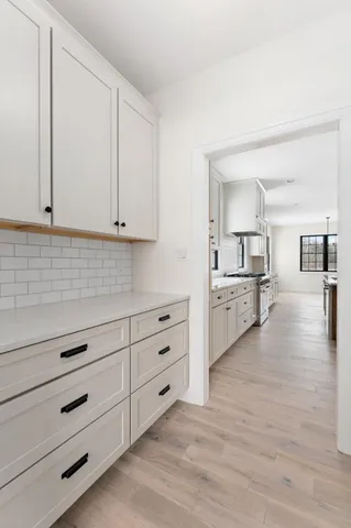 a spacious bathroom with a double vanity sink a mirror and a bathtub