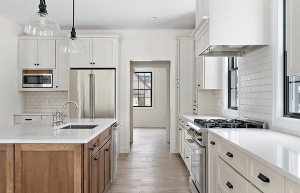 a kitchen with a sink stove and refrigerator